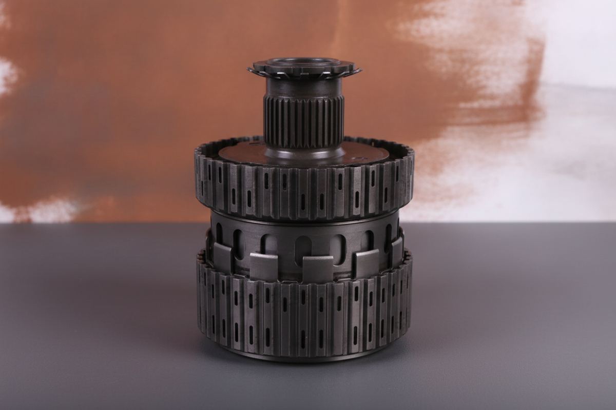 Close-up of a U140/U240 Transmission Planet Set, displaying its gears and durable metal construction on a charcoal surface wi